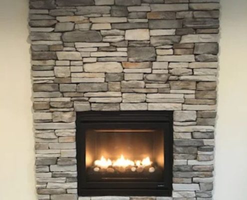stacked stone gas fireplace - We Finish Basements basement finishing near