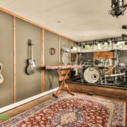 WeFinishBasements-how-to-soundproof-a-basement basement music room with guitars on the wall and a drum set - We Finish Basements